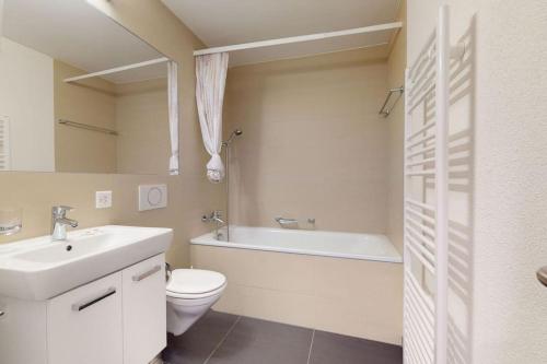 a bathroom with a sink and a toilet and a bath tub at Amazing/sunny 2 bedroom flat in the city center (West 6) in Zurich