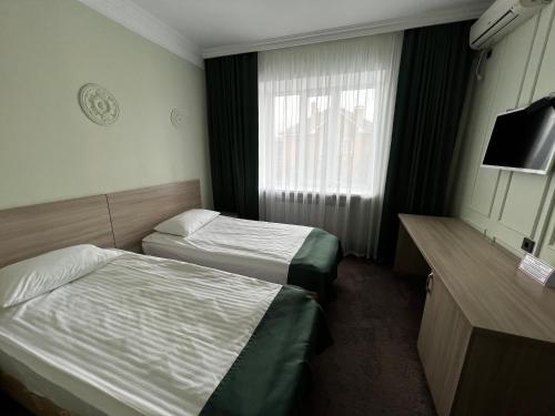 a hotel room with two beds and a window at AQ-JAIYQ in Karagandy