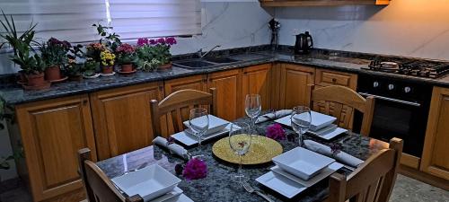 a kitchen with a dining table with glasses on it at The Palm Villa in St Paul's Bay