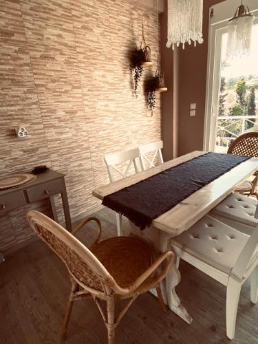 a dining room with a table and chairs at KIPOS-SS residences in Dassia