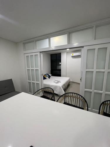 a room with a room with a bed and chairs at Hotel Cabañas Villa Roca, Rodadero in Santa Marta