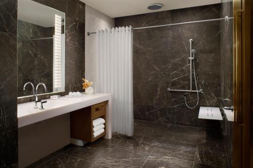 a bathroom with a sink and a shower at The Ritz-Carlton, Melbourne in Melbourne