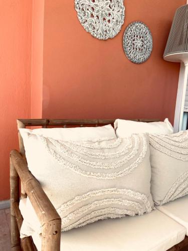a bed with white pillows and plates on a wall at KIPOS-SS residences in Dassia
