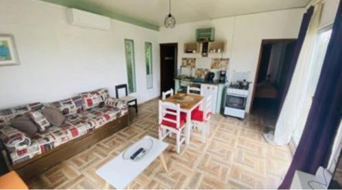 a living room with a couch and a table at Alma Mía in Villa Serrana