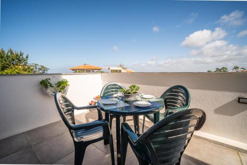 a table and four chairs on a patio at BmyGuest - Sesimbra Country View Villa in Sesimbra