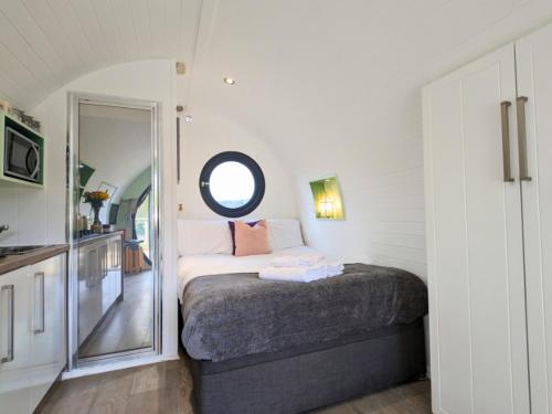 a bedroom with a bed and a large mirror at The Heron's Tree in Llandovery