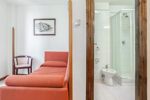 a bathroom with a bed and a shower and a toilet at Hotel Villa d'Amato in Palermo