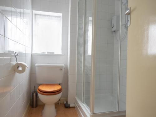 a bathroom with a toilet with a glass shower at The Kildare in Skegness