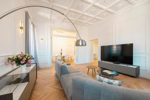 a living room with a large couch and a tv at SJR Luxury Apartment Trevi Fountain in Rome