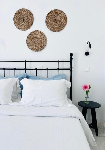 a bedroom with a black bed with white pillows at Villa Fotini in Firostefani