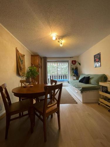 un salon avec une table et un canapé dans l'établissement Studio La Case de l’Écureuil, à Barcelonnette