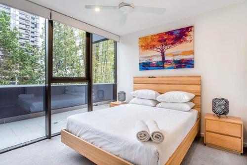 a bedroom with a bed with two towels on it at Urban Luxury - Discover this City Escape in Brisbane