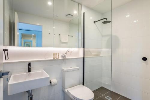 a bathroom with a toilet and a sink and a shower at Urban Luxury - Discover this City Escape in Brisbane