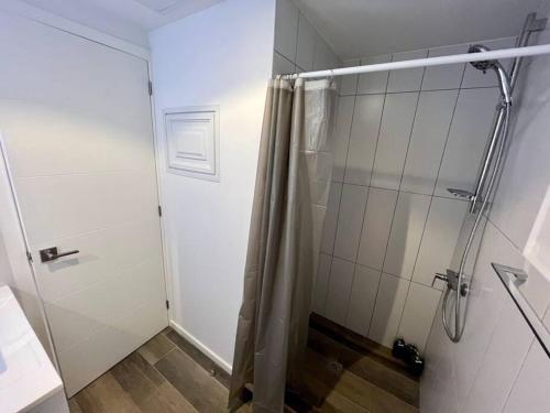 La salle de bains est pourvue d'une douche avec une porte en verre. dans l'établissement Medju - Elegant Apartment, à Guatemala