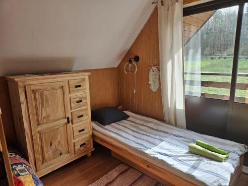 a small bedroom with a bed and a window at Grabówka in Nadole