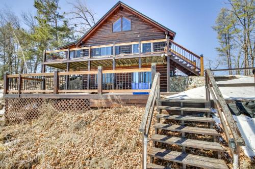 a log home with stairs leading up to it at Lakefront Park Rapids Cabin with Decks and Boat Dock! in Park Rapids