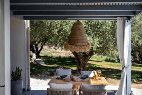 a table with chairs and a basket hanging over it at Tree of Life in Valeriános