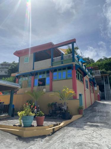 a colorful house with potted plants in front of it at Taste Of Freedom in Brighton Village