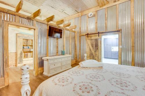 a bedroom with a bed and a dresser in a room at Downtown Lineville Vacation Rental about 10 Mi to Lake in Lineville