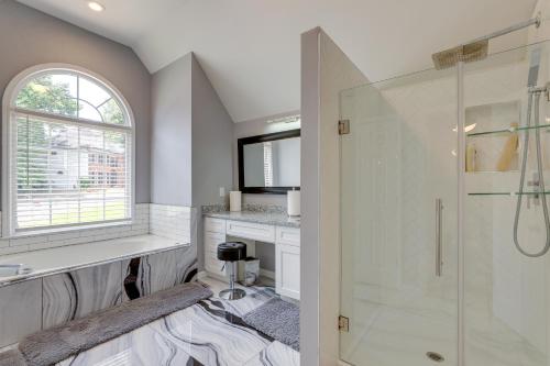 a white bathroom with a shower and a sink at Spacious Home about 7 Mi to Stone Mountain Park! in Stone Mountain