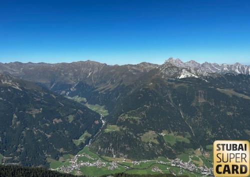 arial view of a mountain range with a sign at Berghaus Martin in Neustift im Stubaital