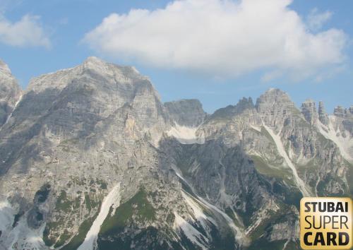 a large mountain range with a sign in front of it at Berghaus Martin in Neustift im Stubaital