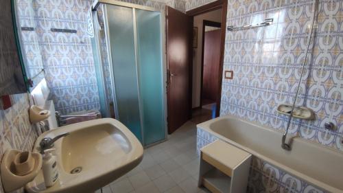 a bathroom with a sink and a bath tub at Villa Elisa in Cuccurano