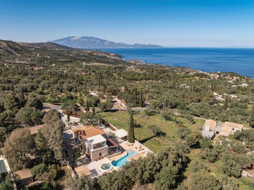 an aerial view of the house and the ocean at Louiza - Luxury Stone Villa in Volímai