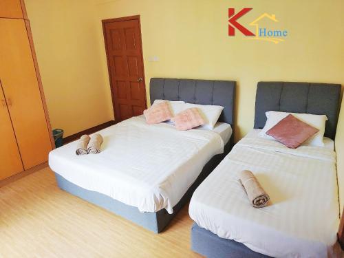 two beds in a room with towels on them at KHome-MarinaCourt-KK CITY CENTRE .3B2R(8Pax) NEW!! in Kota Kinabalu