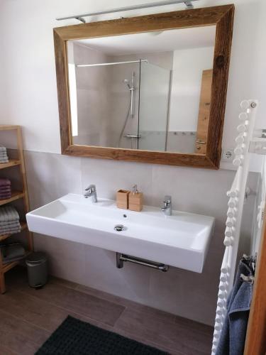a bathroom with a white sink and a mirror at Berghaus Martin in Neustift im Stubaital