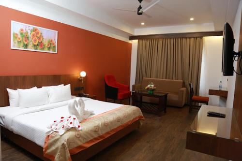 a hotel room with a bed and a living room at HOTEL SKY PARADISE in Iritti
