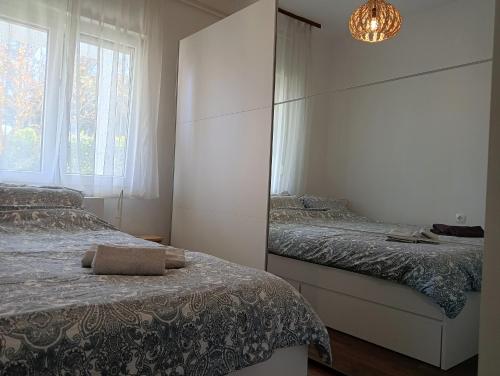 um quarto com 2 camas e um espelho em Apartment Lungomare em Umag