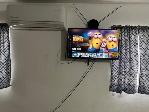 a flat screen tv hanging on a wall at Bonito departamento tipo “estudio” 2 in Ciudad Juárez
