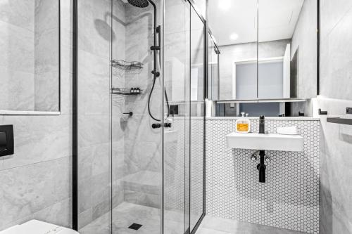 a bathroom with a shower and a sink at Scenic Wollongong Gem - City Location with Rooftop in Wollongong