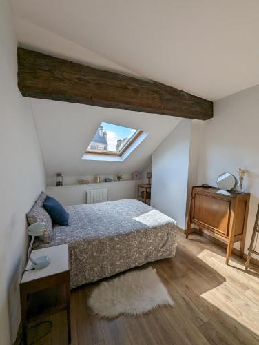 une chambre avec un lit et une lucarne dans l'établissement Lumineux appartement sous les toits à Pey Berland, à Bordeaux