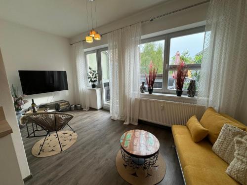 a living room with a couch and a table at Naumburger Charme Solaris in Naumburg