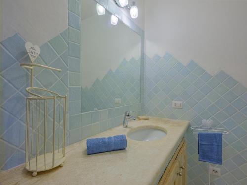 a bathroom with a sink and a mirror at Sardinia Family Villas - Villa Brunilde with private pool in Arzachena