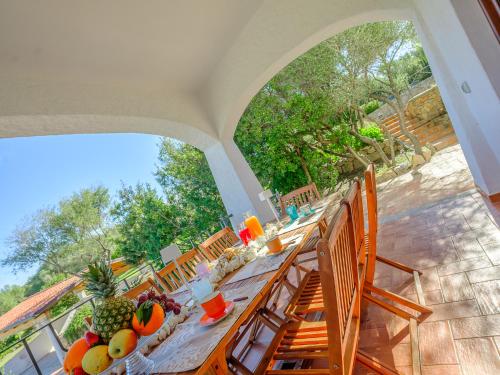 a table with fruit on it on a patio at Sardinia Family Villas - Villa Brunilde with private pool in Arzachena