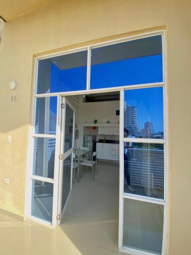 a large window in a room with a view of a kitchen at Hotel Cabañas Villa Roca, Rodadero in Santa Marta