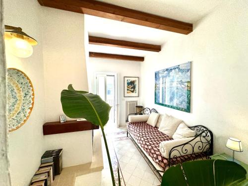 a living room with a couch and a plant at La Torretta - Marea Stays Collection in Otranto
