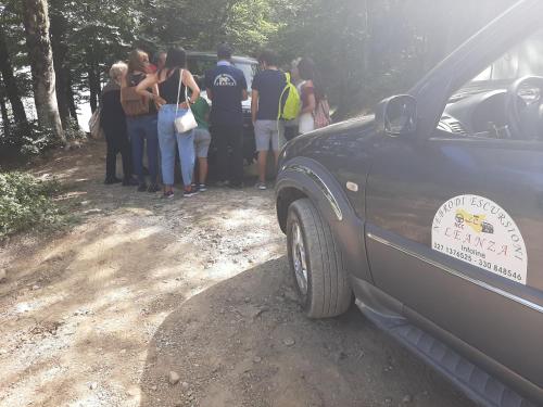 a group of people standing next to a car at BB Cesarò Mariolo house in Cesarò