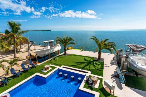 a house with a swimming pool and a boat at Tavernier Ocean Vista in Tavernier