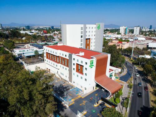 an overhead view of a white building with a red roof at Holiday Inn Guadalajara Patria-Universidad by IHG in Guadalajara