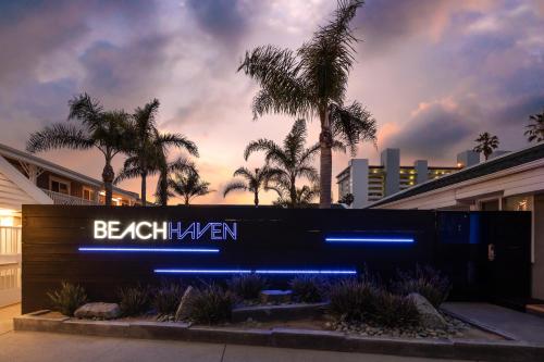 a sign in front of a building with palm trees at Beach Haven in San Diego