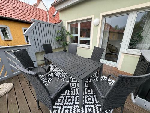 a wooden table and chairs on a deck at Naumburger Charme Solaris in Naumburg