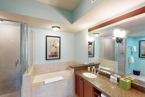 a bathroom with two sinks and a shower at Halii Kai 18E in Waikoloa