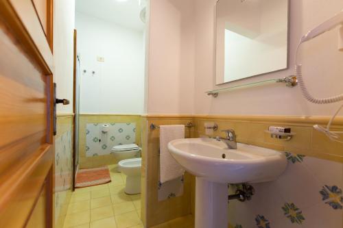 a bathroom with a sink and a toilet at Case Vacanze Margherita in Lipari
