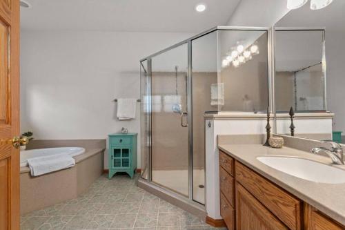 a bathroom with a shower and a sink and a tub at Kalbus House- Lake Winnebago access across the street in Oshkosh