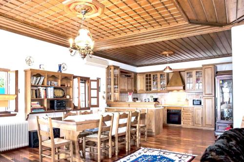 a kitchen with a table and chairs in a room at Spacious house with sea view in Volos in Volos