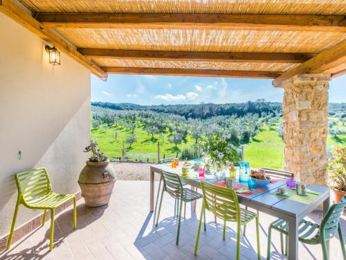 een patio met een tafel en stoelen en uitzicht bij Holiday Home Nena by Interhome in Casale Marittimo